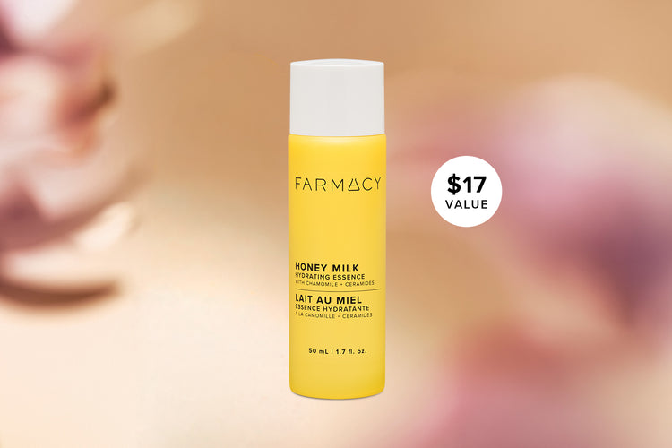 Farmacy Honey Milk Hydrating Essence 50 mL (1.7 fl. oz.) bottle with a $17 value badge against a softly blurred pink and gold background