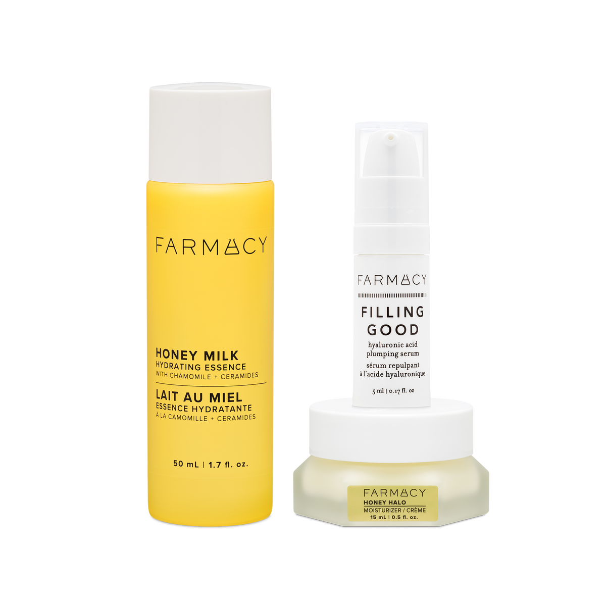 Farmacy Hydration Essentials Trio featuring Honey Milk Essence 50 mL, Honey Halo Moisturizer 15 mL and Filling Good Serum 5 mL on a white background