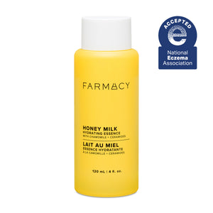 Yellow bottle of Farmacy Honey Milk Hydrating Essence on a white background with National Eczema Association acceptance badge.